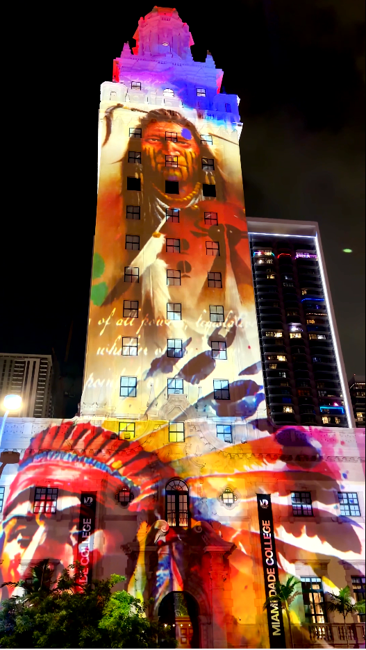 Layered historical portrait and archival imagery projected on the Freedom Tower
