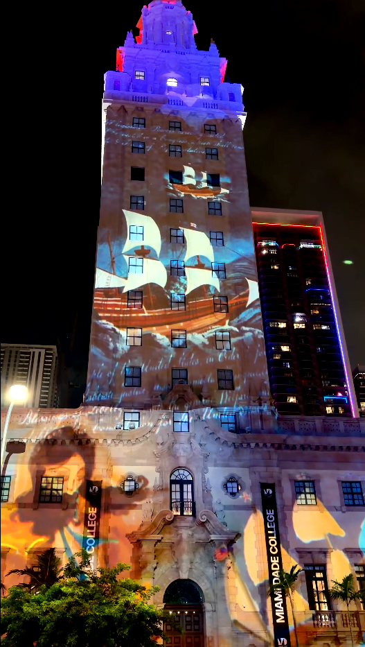 Historic sailing ships projected across the Freedom Tower facade
